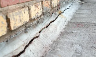 Structural crack in exterior brick wall before foundation crack repair