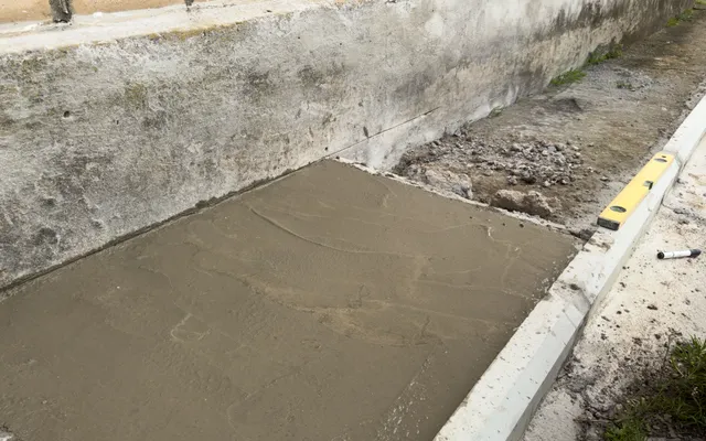 Professional foundation repair team leveling a residential brick home in Tyler, TX